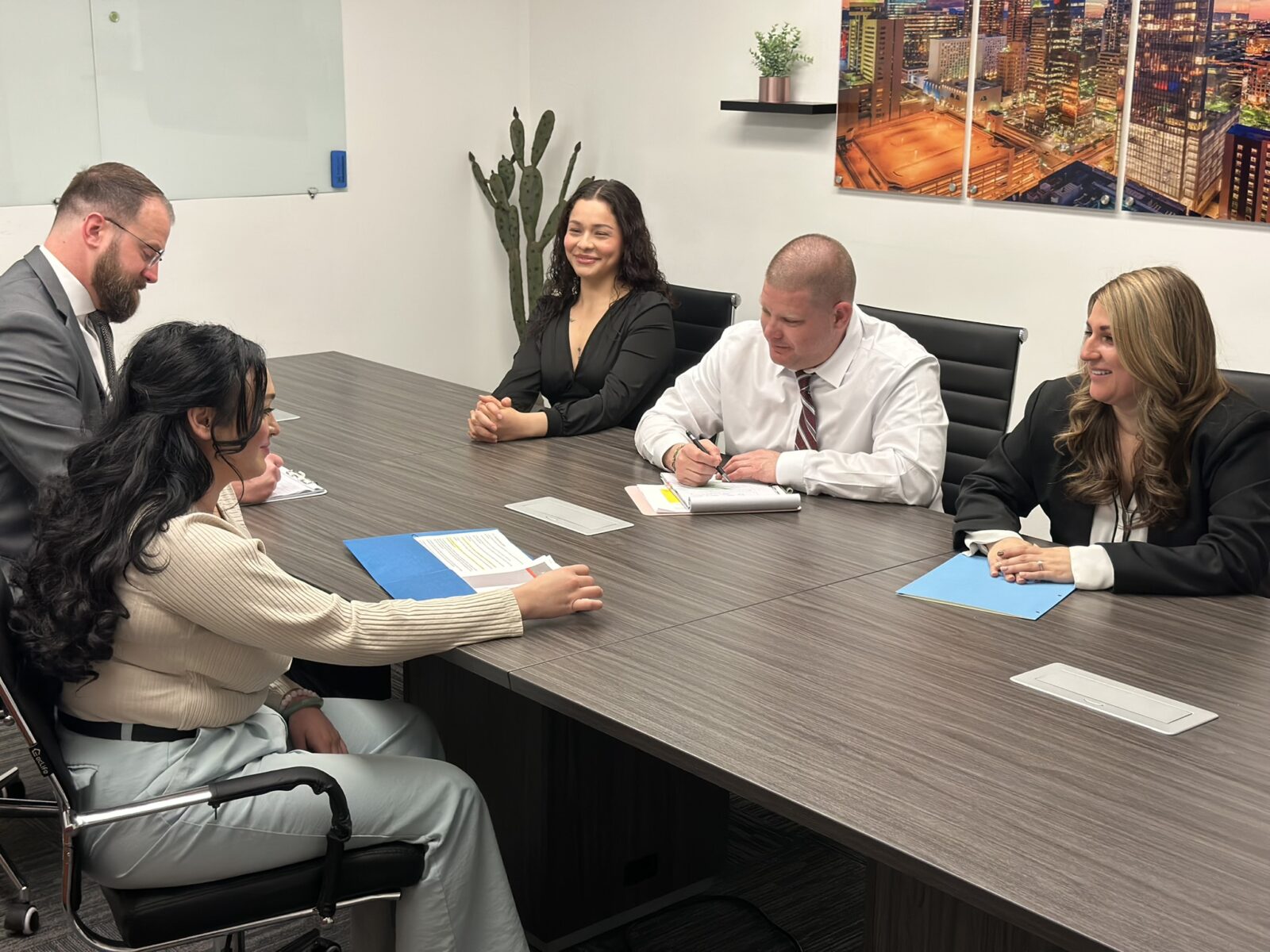 Esquire Law attorneys assisting a client in a conference room